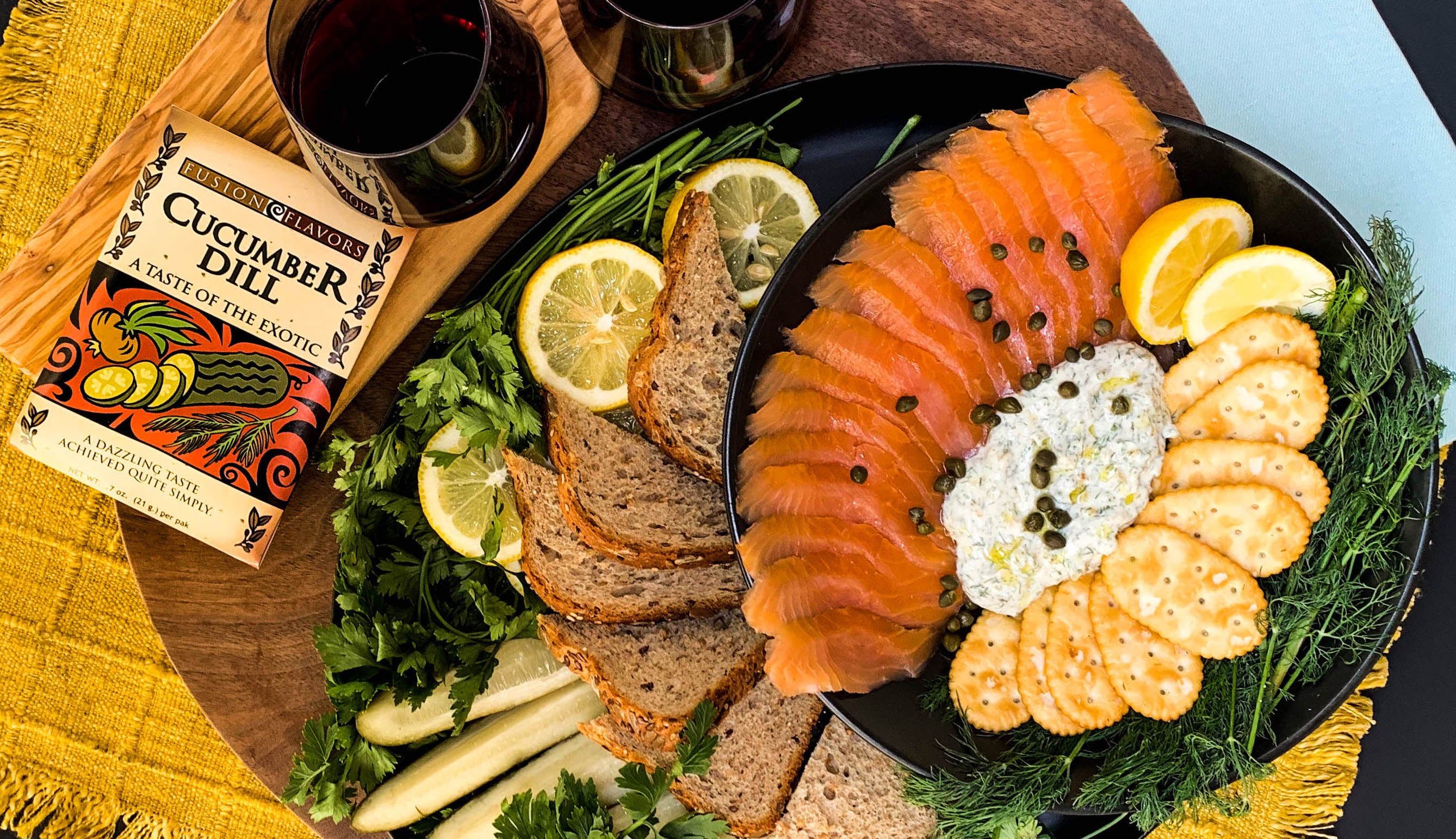 Dill dip in center of charcuterie board with smoked salmon and crackers around the dip. Garnished with capers, lemon wedges and rye bread slices.