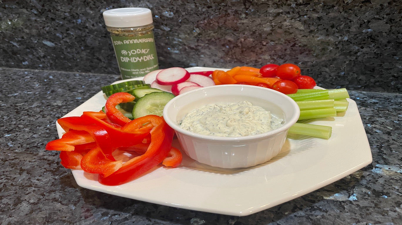 Beautiful white plate with fresh, vibrant veggies cut up and plated with Dip-idy Dill dip from Jodie's Kitchen
